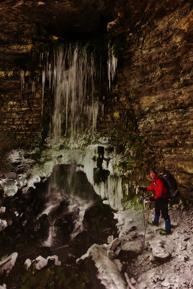 Dan Nash of Satori Adventures approaches a frozen waterfall with his Mountainsmith Mystic backpack