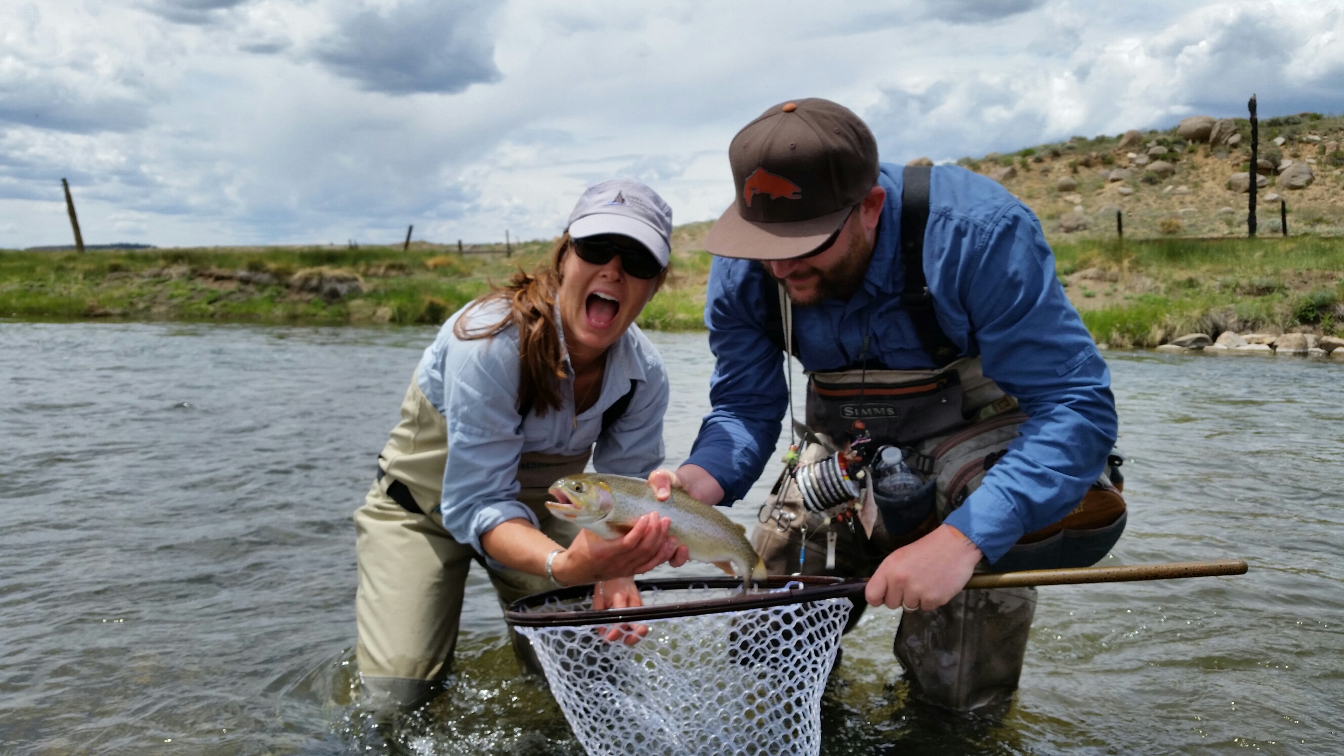Ashley Tucker shown holding a cutbow trout while fishing the South Platte River in Colorado. 