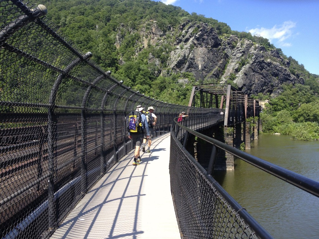 Hikers leaving Harper's Ferry, West Virginia and crossing the Potomac River bridge into Maryland.  