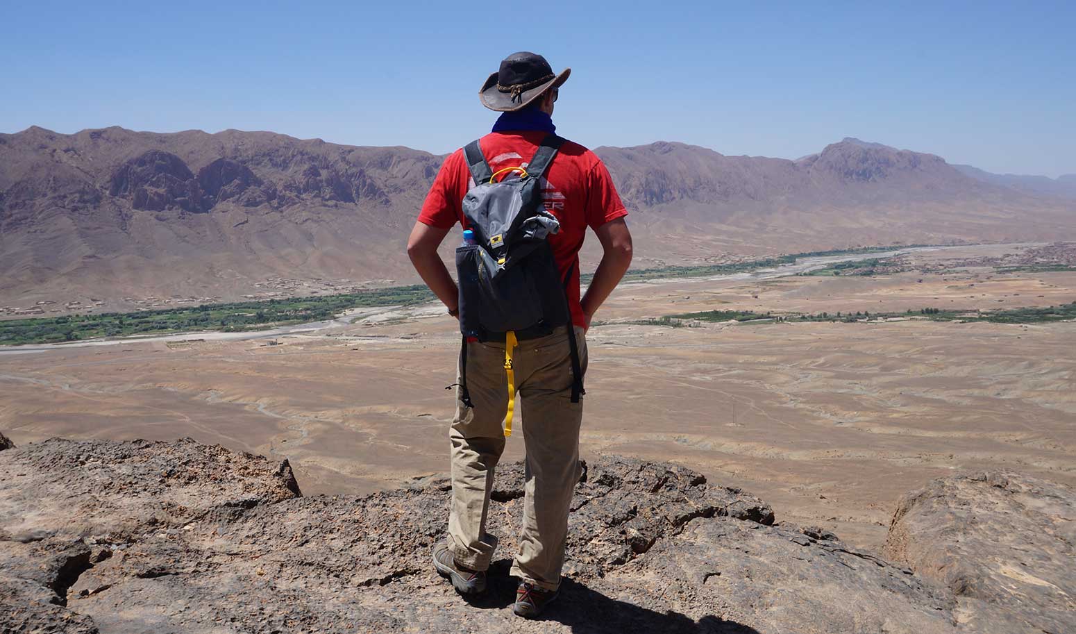 Henry "Ted" Kernan member of Team Spontaneous Khanbustion racing in the 2014 Mongol Rally, and Mountainsmith Brand Ambassador is pictured wearing the Mountainsmith Scream backpack over looking a river gorge.