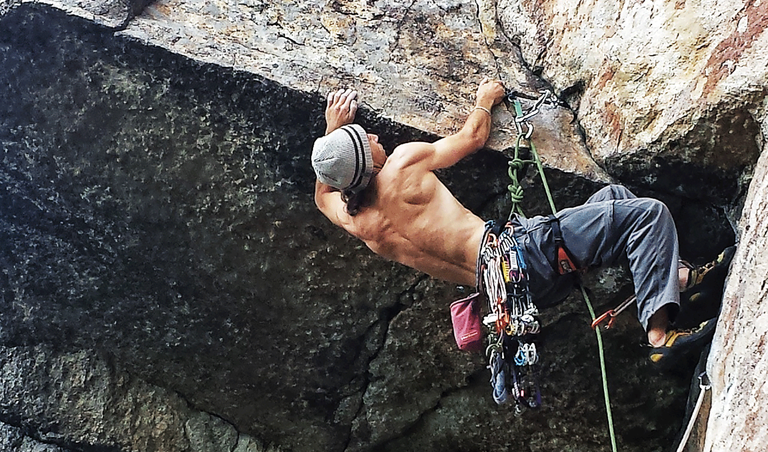 Chris Vultaggio, professional photographer and Mountainsmith Ambassador is shown climbing an over-hanging, blocky route. 