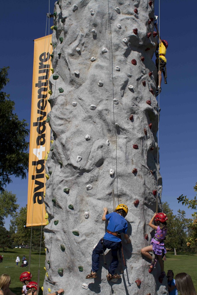 Kids testing out the climbing wall at Backpacker Magazine's Adventures Denver