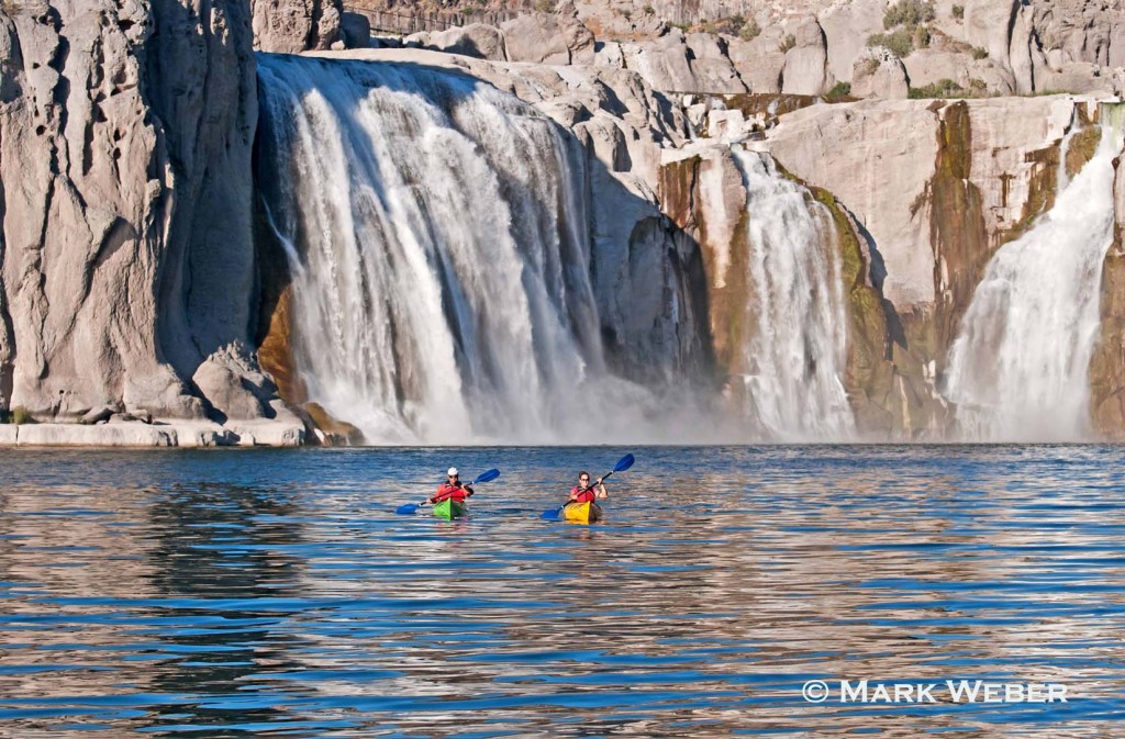 Jessica and Eddie Florian paddling kayaks below Shoshone Falls on the Snake River in the Snake River Canyon near the city of Twin Falls in southern Idaho