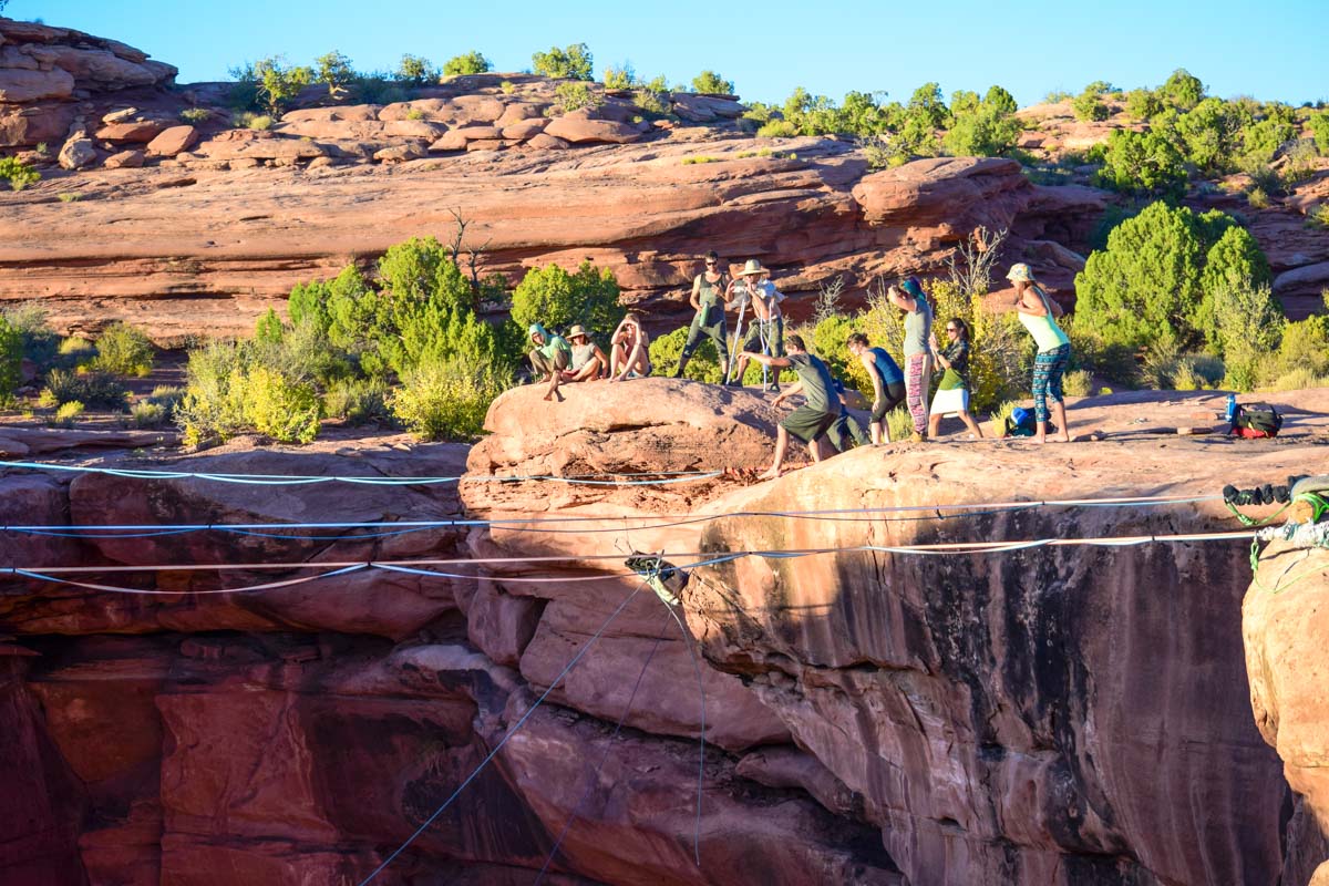 Elliot Bernhagen tosses a loaded haul-bag over the edge. This is how we simulated a jumper to test the rigging before we sent the first human over. Moab, utah, giant swing