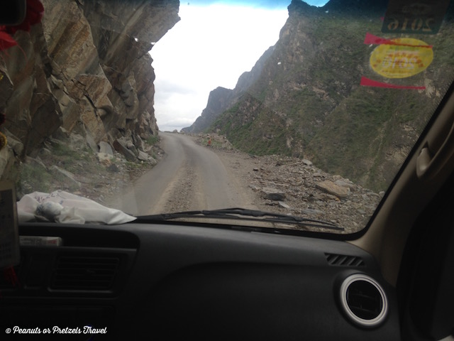 Car on road into Tiger Leaping Gorge, China