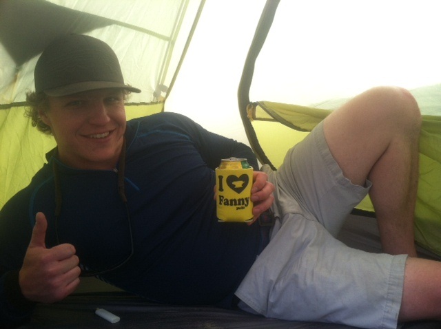 Josh Jacobson inside a mountainsmith morrison 2 tent drinking a beer out of an I heart fanny packs coozy