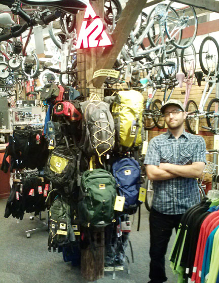 Greg from Onion River Sports standing proudly by the Mountainsmith pack display…