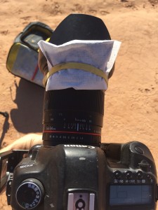 Hand warmer attached to camera lens with rubberband