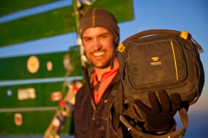 Garrett Adrian holds his Mountainsmith Swift FX on the summit of Mt. Kilimanjaro in tanzania