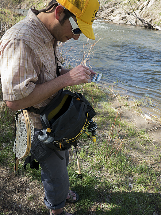 Mountainsmith President, Jay Getzel shown with his Mountainsmith Tour TLS Lumbar Pack while out fly fishing on a river in Denver Colorado.  