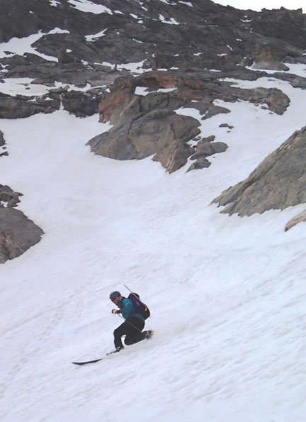 Jay Getzel laying down some fun telemark turns as the couloir opens into the snowfield below on Mt. Evans