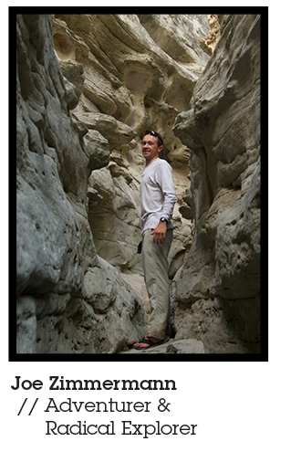 Joe Zimmermann, adventurer, idea man behind the Blackwater Drifters Expedition, and Mountainsmith Ambassador pictured hiking through a slot canyon in a white long sleeve shirt and khaki pants. 