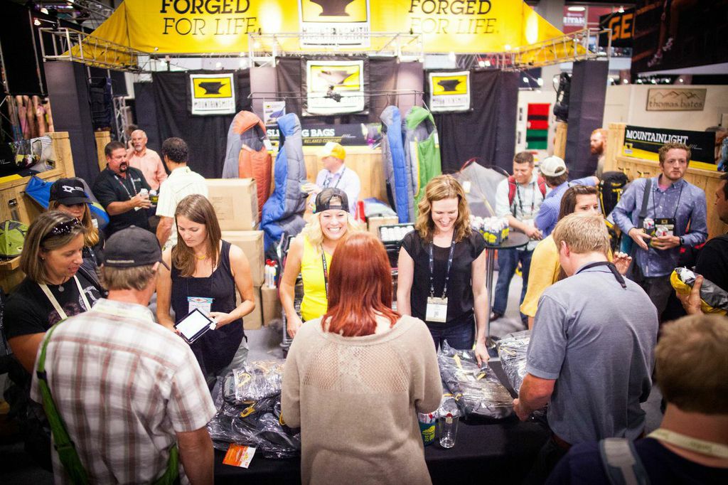 Employees of True Hero sell backpacks at the Mountainsmith during Outdoor Retailer summer 2014