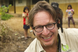 Dean Jacobs with a monkey on his shoulder in the Achuar jungle of the Amazon rainforest