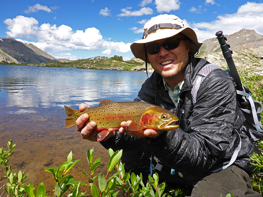 Jonathan Hill holds a cutthroat trout in Colorado with this Mountainsmith Scream 25 backpack