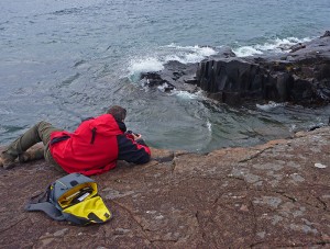 Randy Wilson taking a photo with his Mountainsmith Spectrum Camera backpack in the Boundary Waters Canoe Area