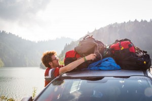 Ben Roif straps the Mountainsmith Travel Trunks ot the roof of his car