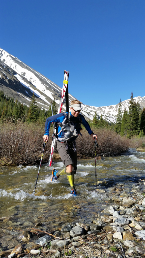 Darrin Young of Smartwool crosses a stream at the base of Torrey's Peak