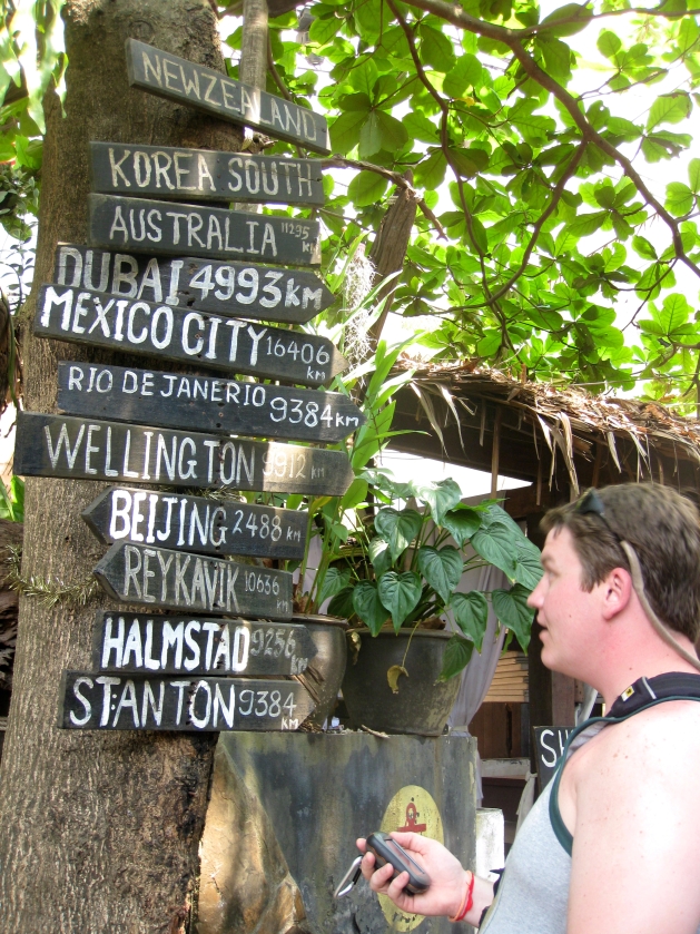 Josh Wilson reads a sign in Ko Phi Phi, Thailand