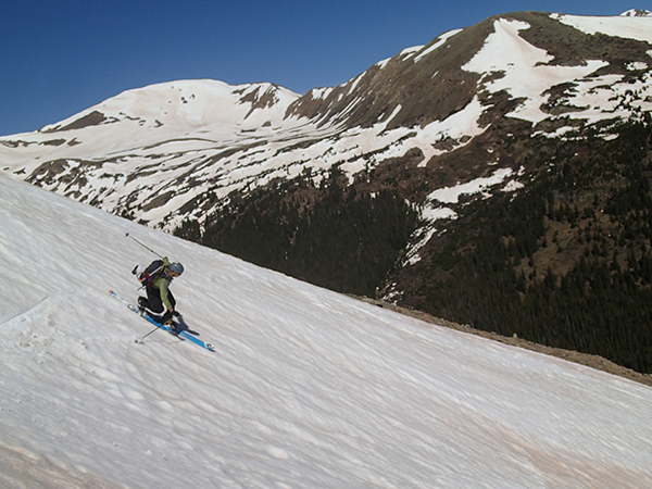 Jay Getzel telemark skis down a snow field on Torrey's Peak in Colorado 