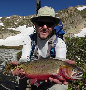 fisherman holding a cuttthroat trout