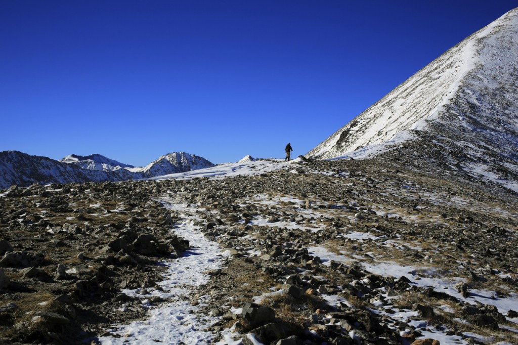 A hiker heads up the ridge of quandary peak in colorado during the winter