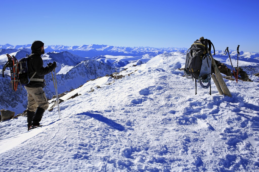 The Mountainsmith Ghost 50 backpack with snowshoes on top of Quandary peak in winter 