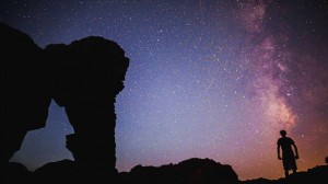 Derrick Lytle, photographer and Mountiansmith Ambassador pictured in front of a stone arch and start night sky in the Valley of Fire.