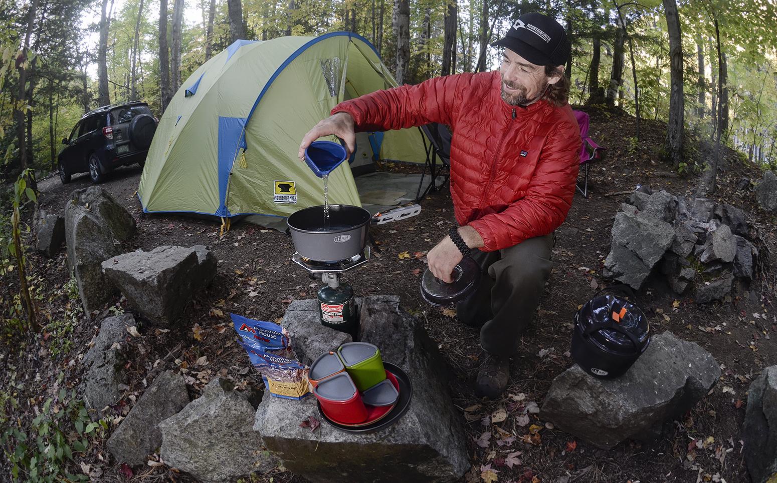 Curtis Savard prepares food at his campsite in front of the Mountainsmith Conifer tent