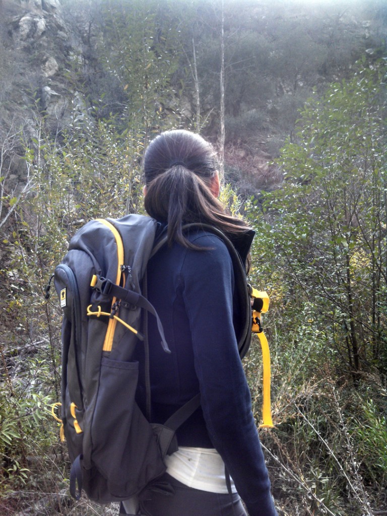 a girl wears the Mountainsmith Wraith 25 backpack