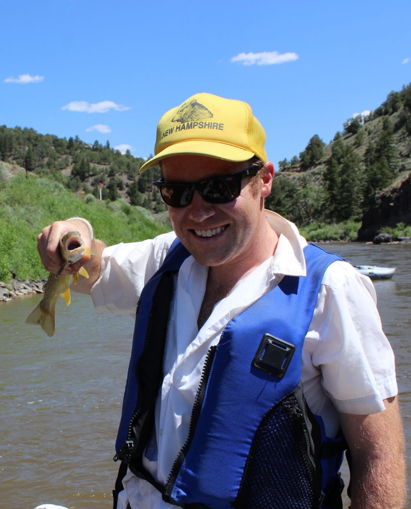 Jeremy Dodge holding a brown trout on the colorado river