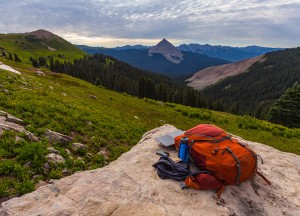 Backpack and solar charger atop a cliff on COlorado Trail