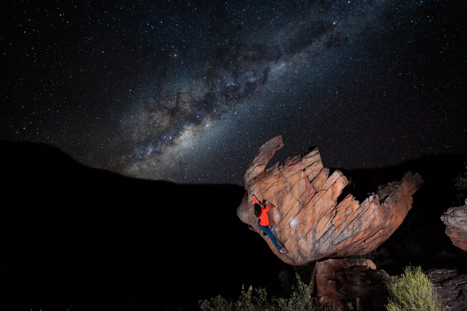 climber in front of the milky way in the night sky