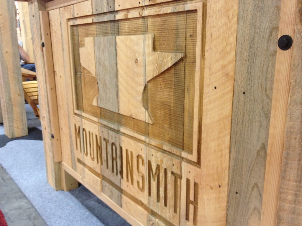 The Mountainsmith logo carved into the front desk of their trade show booth for outdoor retailer