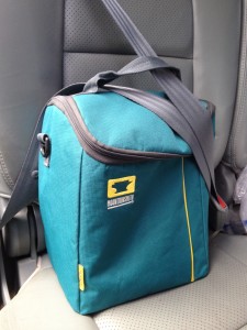 The Mountainsmith Sixer Cooler buckled into the back seat of a car.