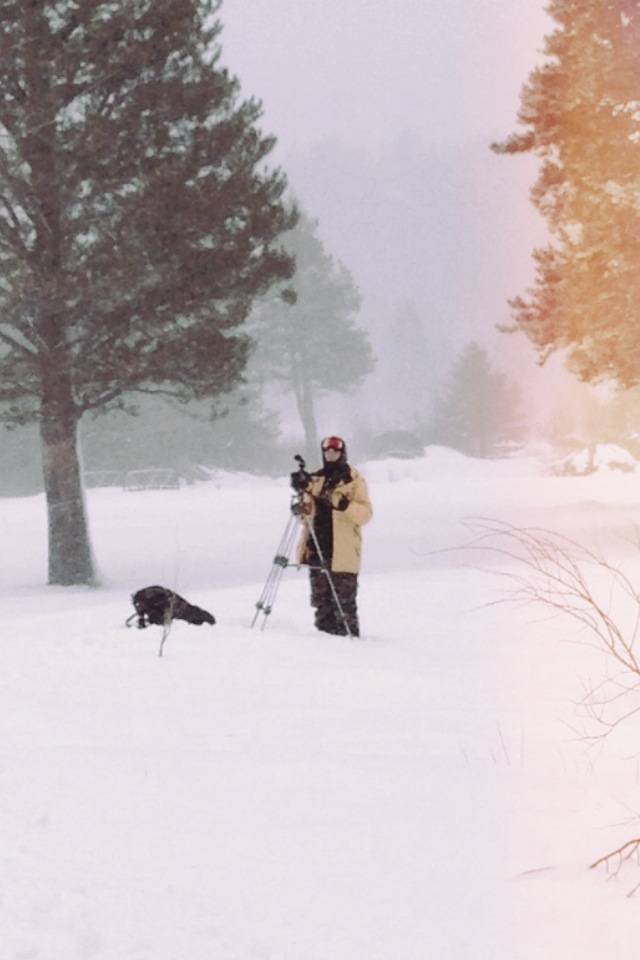 AJ Marino shoots skiers with his video camera on a tripod in meyers. california