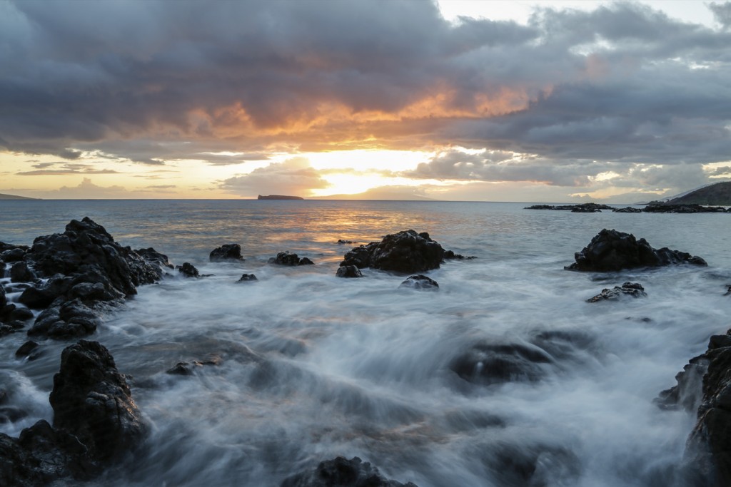 a long exposure sunset view of molokini island from maui in hawaii